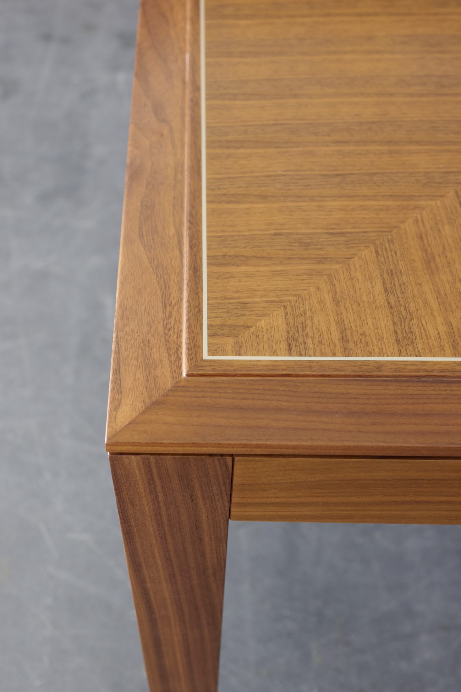 Detail of parquetry inlay and corner joinery on a bespoke dining table